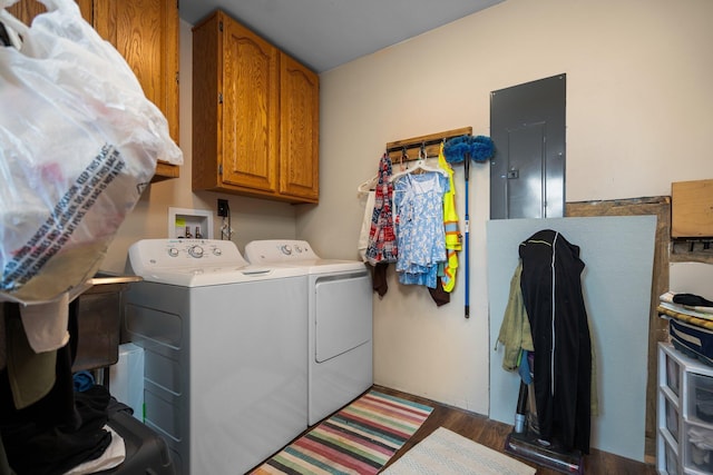 8406 S Shire Rd, Vanderbilt, MI 49795 - laundry room with washing machine and dryer, electric panel, cabinet space, and wood finished floors