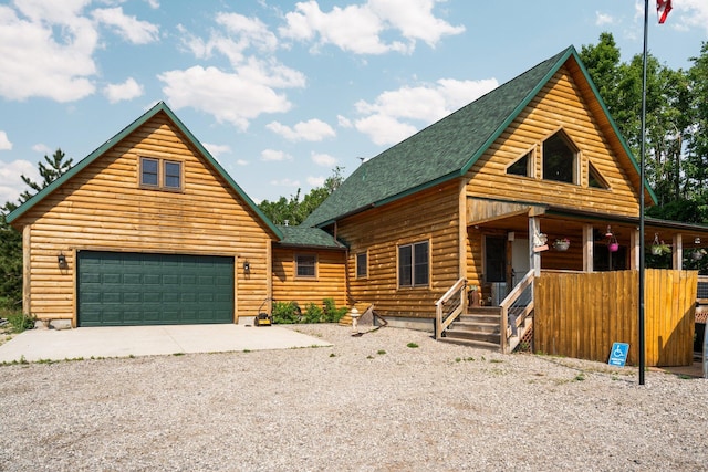 8406 S Shire Rd, Vanderbilt, MI 49795 - view of front of property with roof with shingles, covered porch, driveway, and a garage