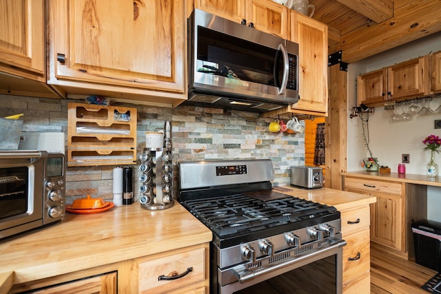 8406 S Shire Rd, Vanderbilt, MI 49795 - kitchen featuring stainless steel appliances, wood counters, decorative backsplash, and wooden ceiling