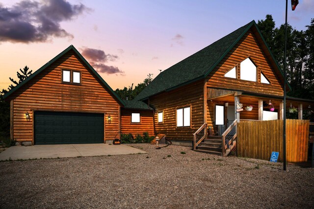 8406 S Shire Rd, Vanderbilt, MI 49795 - view of front of home featuring roof with shingles, a garage, and gravel driveway