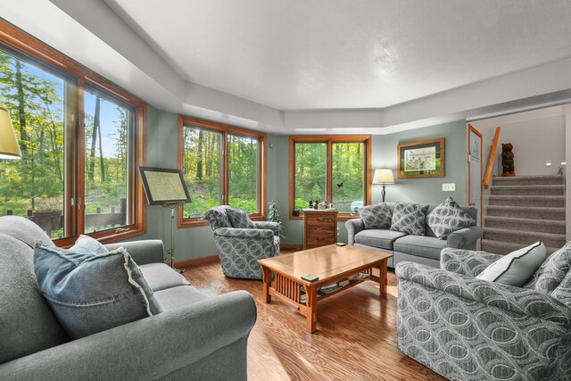211 Gardners Grv, Roscommon, MI 48653 - living room featuring wood finished floors, stairs, and baseboards