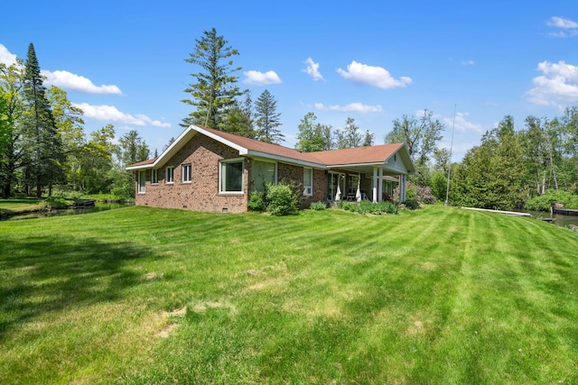 3869 Club Rd, Indian River, MI 49749 - view of home's exterior with crawl space, a lawn, and brick siding