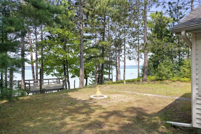 215 Pine Bluffs Rd, Roscommon, MI 48653 - view of yard featuring a water view and a fire pit