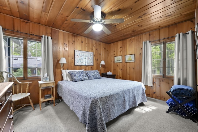215 Pine Bluffs Rd, Roscommon, MI 48653 - bedroom with wooden ceiling, light colored carpet, multiple windows, wooden walls, and a ceiling fan
