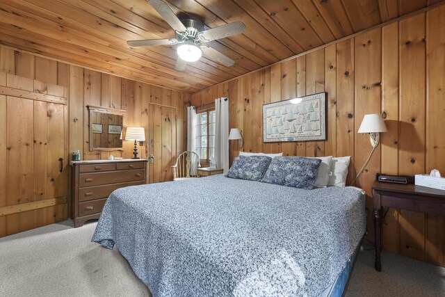 215 Pine Bluffs Rd, Roscommon, MI 48653 - carpeted bedroom featuring wood ceiling, wooden walls, and ceiling fan