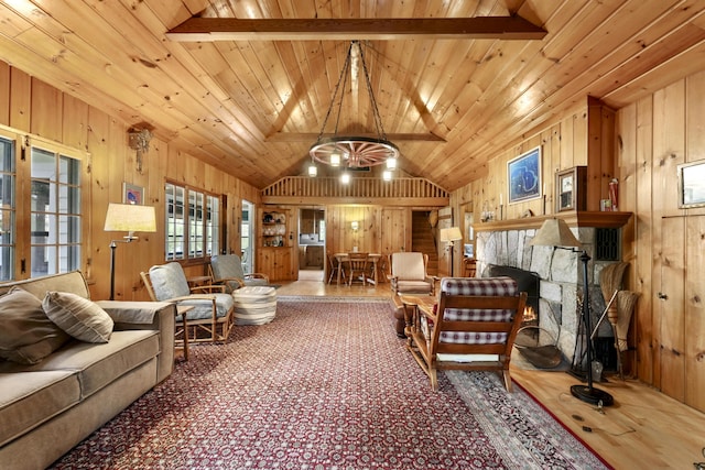 215 Pine Bluffs Rd, Roscommon, MI 48653 - living area with wood walls, lofted ceiling, wooden ceiling, and a fireplace