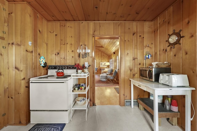 215 Pine Bluffs Rd, Roscommon, MI 48653 - kitchen with white range with electric cooktop, stainless steel microwave, wood ceiling, and wood walls