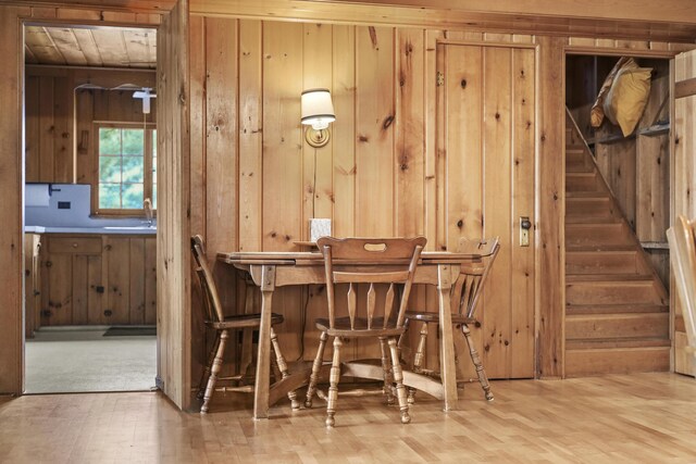 215 Pine Bluffs Rd, Roscommon, MI 48653 - dining space with wooden walls and stairs