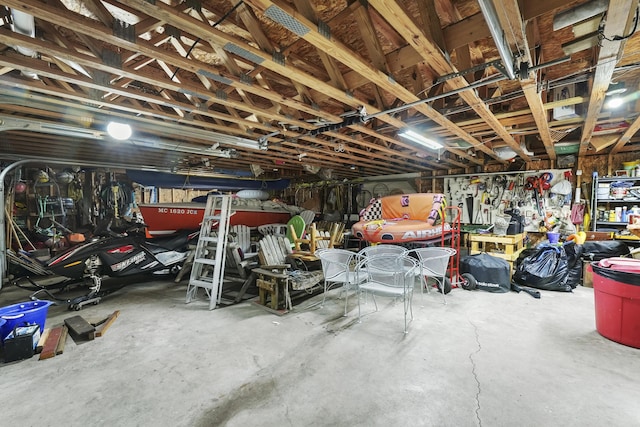 215 Pine Bluffs Rd, Roscommon, MI 48653 - garage featuring a workshop area