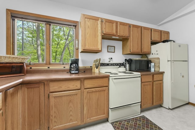 215 Pine Bluffs Rd, Roscommon, MI 48653 - kitchen featuring white appliances and lofted ceiling
