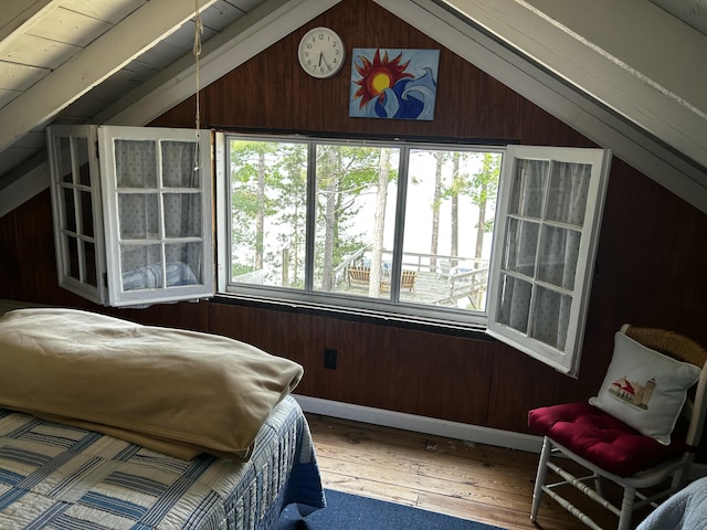 215 Pine Bluffs Rd, Roscommon, MI 48653 - bedroom with vaulted ceiling, multiple windows, wooden walls, and hardwood / wood-style flooring