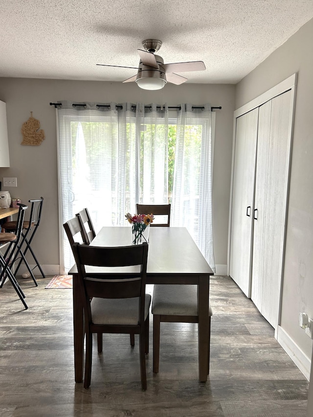 1200 Crestview Dr, Alpena, MI 49707 - dining area featuring a ceiling fan, wood finished floors, a textured ceiling, and baseboards