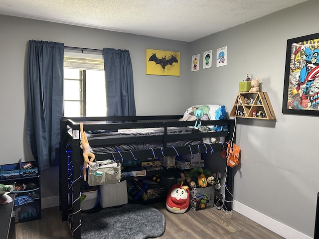 1200 Crestview Dr, Alpena, MI 49707 - bedroom featuring wood finished floors, a textured ceiling, and baseboards