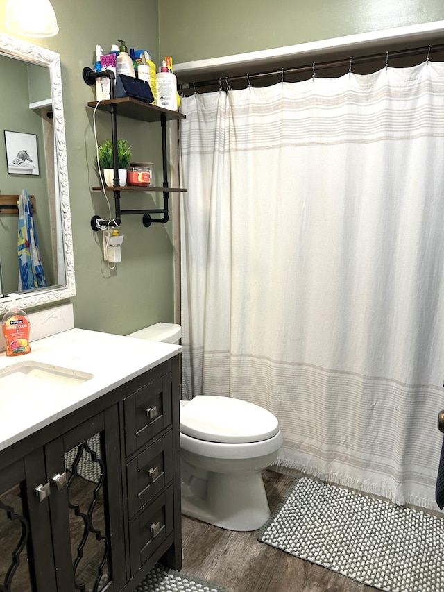 1200 Crestview Dr, Alpena, MI 49707 - bathroom with wood finished floors, toilet, and vanity