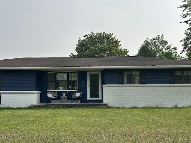 1200 Crestview Dr, Alpena, MI 49707 - single story home featuring brick siding, a front lawn, and a porch