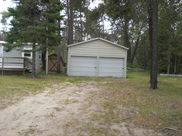 3123 Lovells Rd, Grayling, MI 49738 - detached garage featuring a storage shed