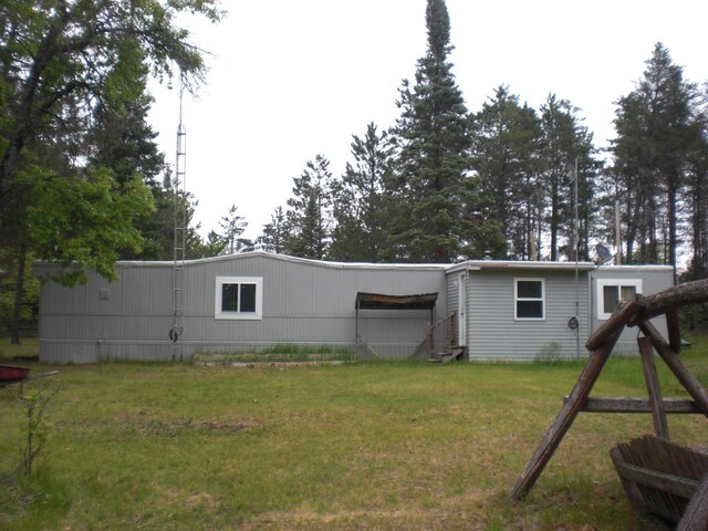 3123 Lovells Rd, Grayling, MI 49738 - back of property featuring entry steps and a lawn