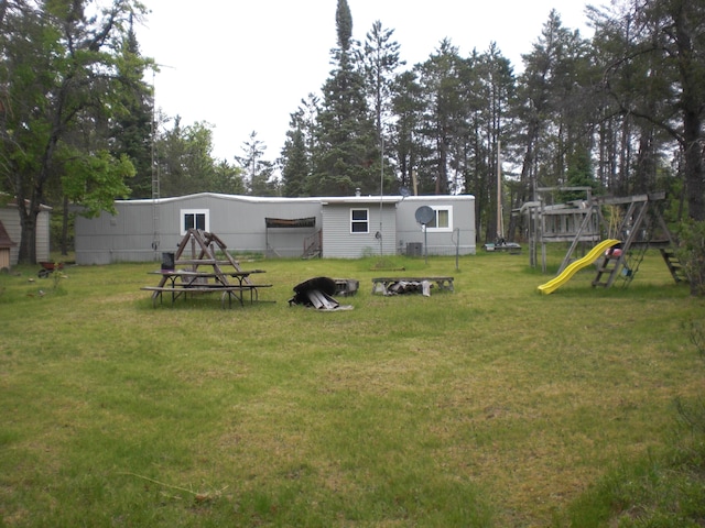 3123 Lovells Rd, Grayling, MI 49738 - view of grassy yard featuring a playground and central air condition unit