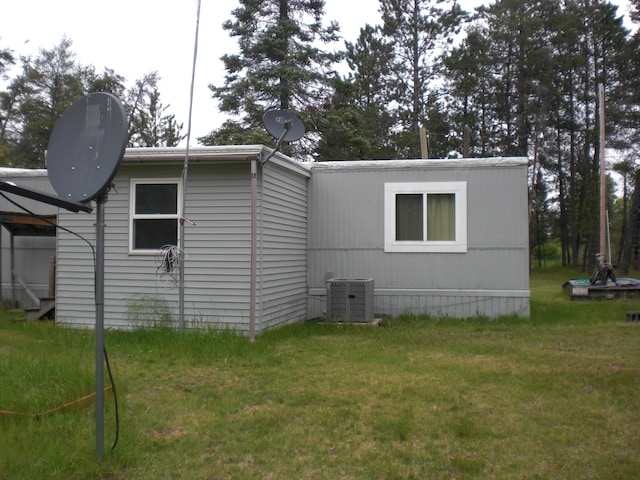 3123 Lovells Rd, Grayling, MI 49738 - view of home's exterior with central air condition unit and a lawn