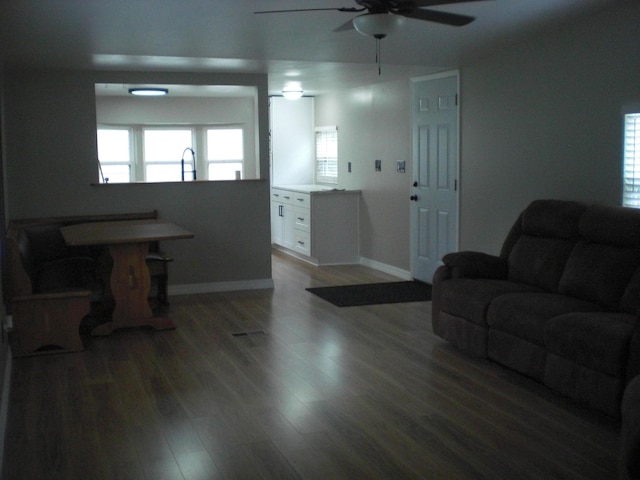 3123 Lovells Rd, Grayling, MI 49738 - living room featuring ceiling fan, baseboards, and wood finished floors