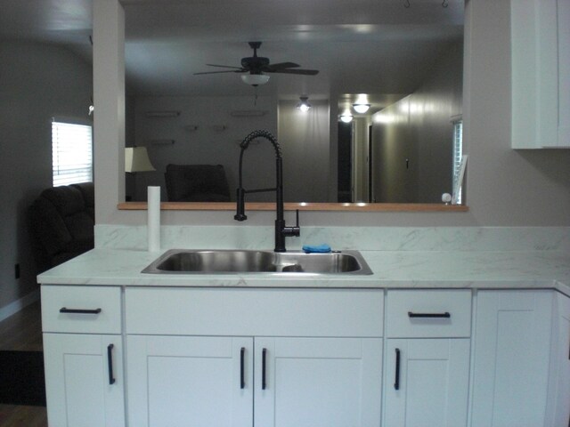 3123 Lovells Rd, Grayling, MI 49738 - kitchen featuring a sink, white cabinets, and a ceiling fan