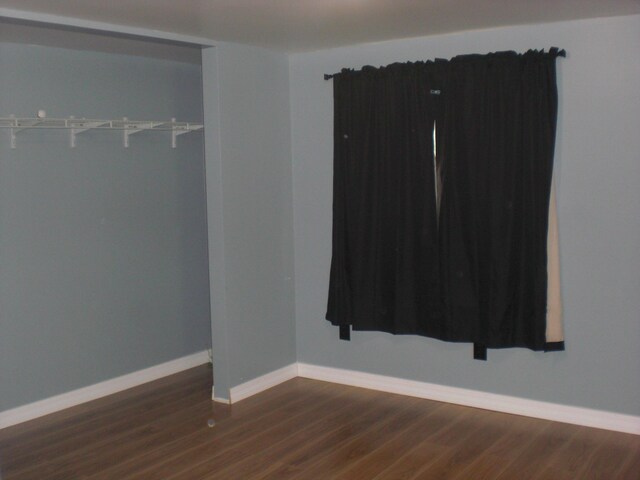 3123 Lovells Rd, Grayling, MI 49738 - unfurnished room with dark wood-type flooring and baseboards