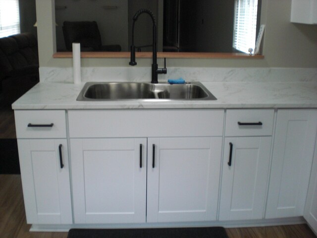 3123 Lovells Rd, Grayling, MI 49738 - kitchen with a sink, white cabinets, and wood finished floors