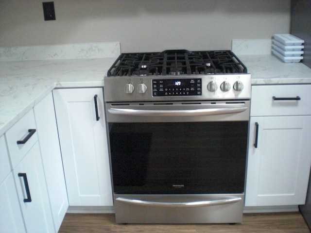3123 Lovells Rd, Grayling, MI 49738 - kitchen view of stainless steel range with gas cooktop, dark wood-style flooring, and light stone countertops