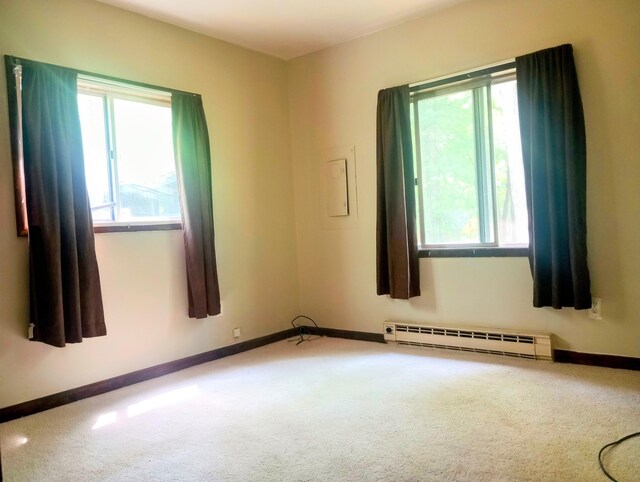 206 Redwine Dr, Houghton Lake, MI 48629 - carpeted spare room with baseboard heating, healthy amount of natural light, and baseboards