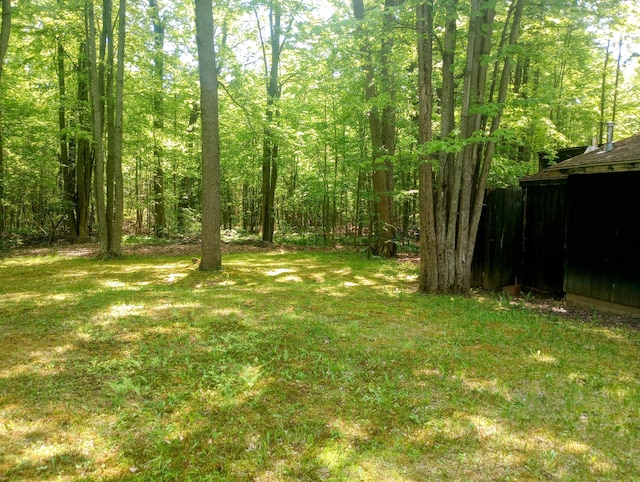 206 Redwine Dr, Houghton Lake, MI 48629 - view of grassy yard featuring a view of trees