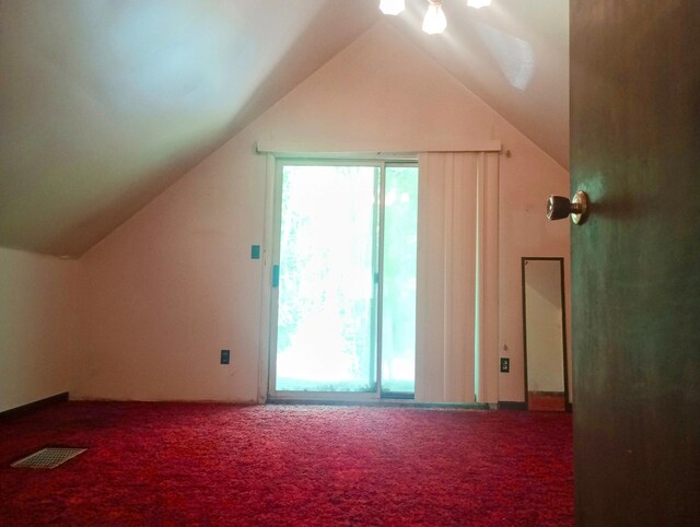 206 Redwine Dr, Houghton Lake, MI 48629 - additional living space featuring carpet flooring, healthy amount of natural light, and vaulted ceiling