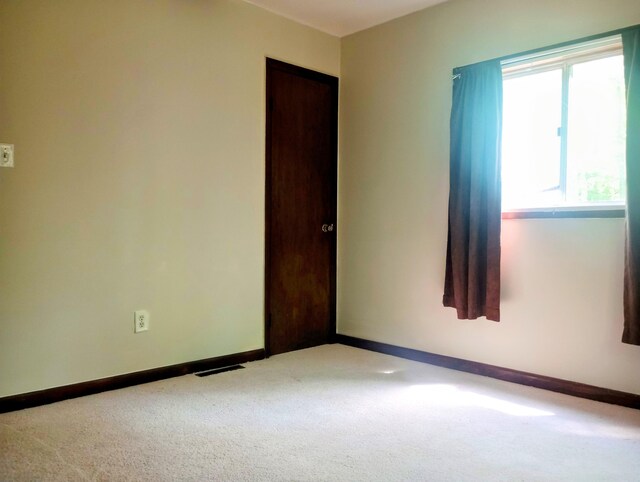 206 Redwine Dr, Houghton Lake, MI 48629 - carpeted spare room with baseboards