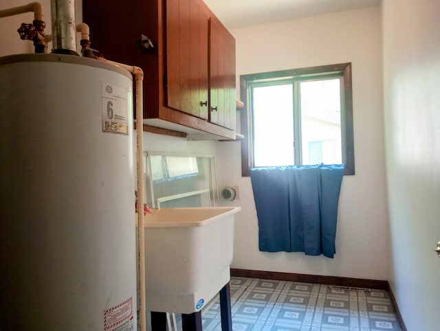 206 Redwine Dr, Houghton Lake, MI 48629 - bathroom featuring gas water heater, tile patterned floors, and a sink