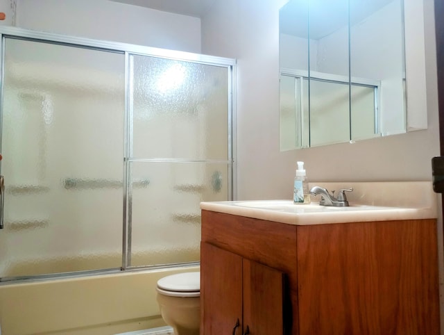 206 Redwine Dr, Houghton Lake, MI 48629 - bathroom featuring toilet, vanity, and bath / shower combo with glass door
