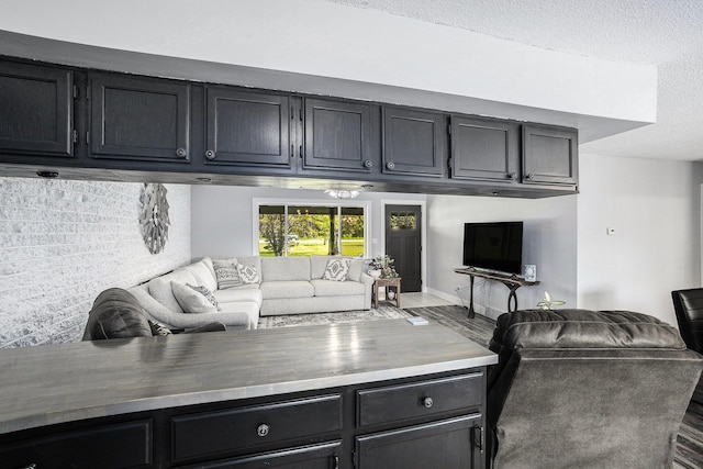 4844 Doerr Rd, Mancelona, MI 49659 - living area featuring wood finished floors, a textured ceiling, and baseboards