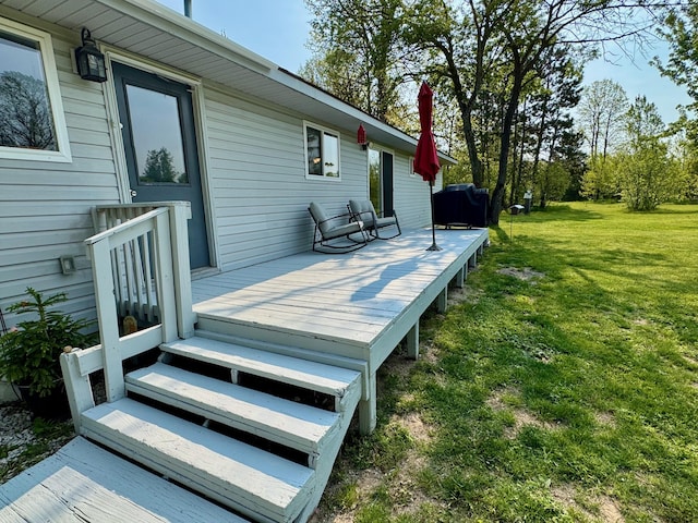 4844 Doerr Rd, Mancelona, MI 49659 - wooden deck featuring a lawn and area for grilling