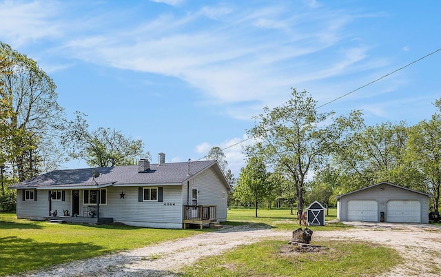 4844 Doerr Rd, Mancelona, MI 49659 - view of side of property featuring a garage, a lawn, covered porch, and a chimney