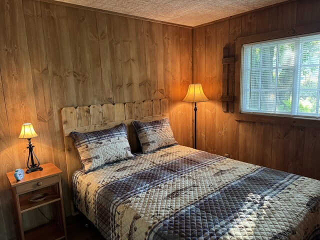 7386 Cheboygan St, Alanson, MI 49706 - bedroom featuring wooden walls