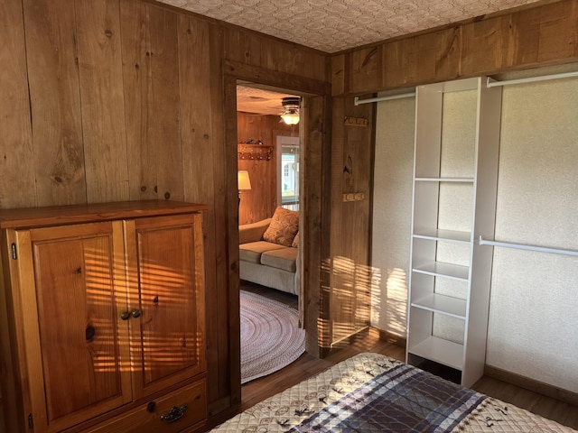 7386 Cheboygan St, Alanson, MI 49706 - unfurnished bedroom featuring wooden walls, wood finished floors, and an ornate ceiling