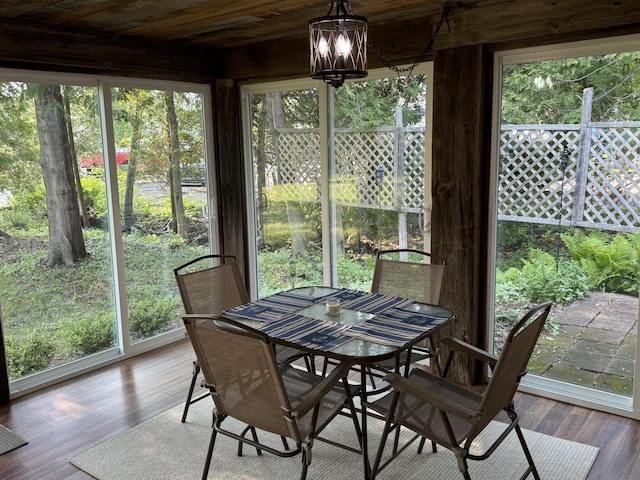 7386 Cheboygan St, Alanson, MI 49706 - sunroom with outdoor dining space, wood finished floors, and wooden ceiling