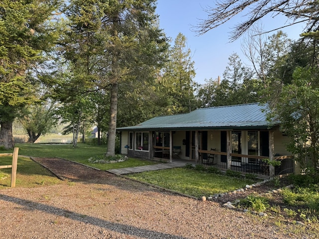 7386 Cheboygan St, Alanson, MI 49706 - view of front of home featuring a front yard, a metal roof, and a porch