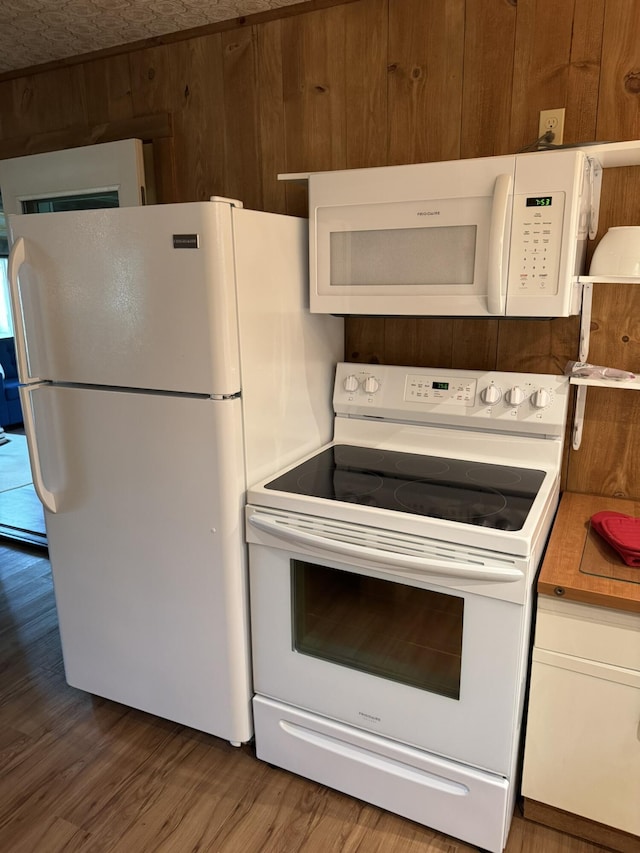 7386 Cheboygan St, Alanson, MI 49706 - kitchen with white appliances, wood finished floors, white cabinetry, and light countertops