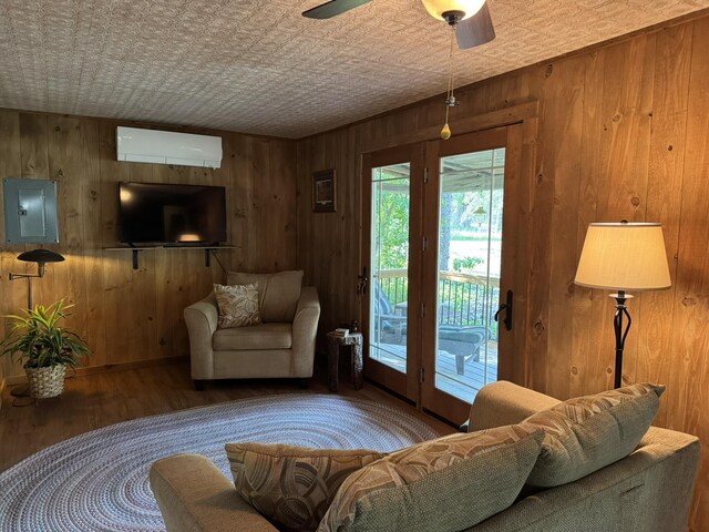 7386 Cheboygan St, Alanson, MI 49706 - living area featuring an ornate ceiling, wood walls, a wall mounted AC, wood finished floors, and electric panel