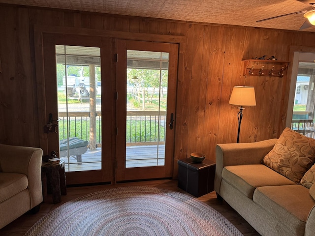 7386 Cheboygan St, Alanson, MI 49706 - living area with wooden walls, healthy amount of natural light, ceiling fan, and wood finished floors