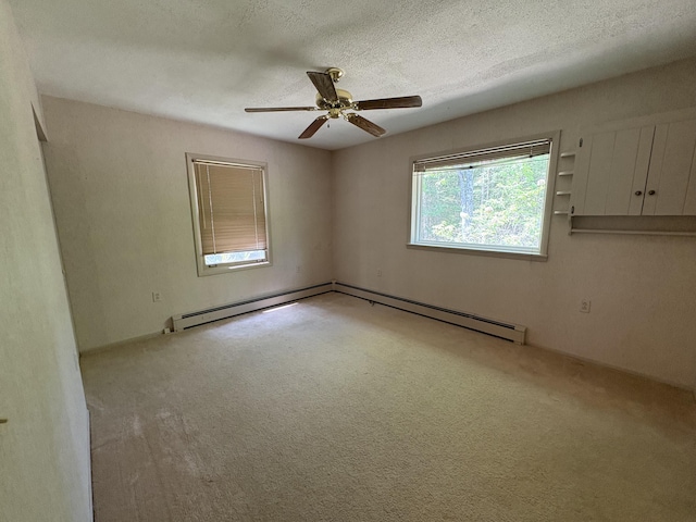 20730 E Riverside Dr, Hillman, MI 49746 - spare room featuring a baseboard radiator, carpet flooring, ceiling fan, and a textured ceiling