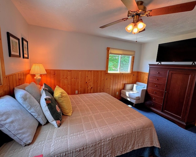 6309 Hiawatha Dr, Frederic, MI 49733 - carpeted bedroom featuring a wainscoted wall, wooden walls, and ceiling fan