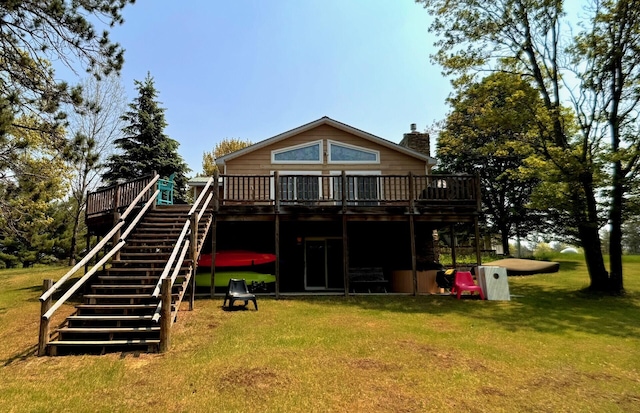 6309 Hiawatha Dr, Frederic, MI 49733 - rear view of house featuring a wooden deck, stairs, a chimney, and a lawn