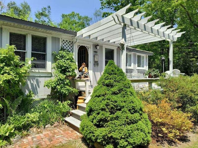 17740 Grand Lake Blvd, Presque Isle, MI 49777 - view of exterior entry featuring a pergola