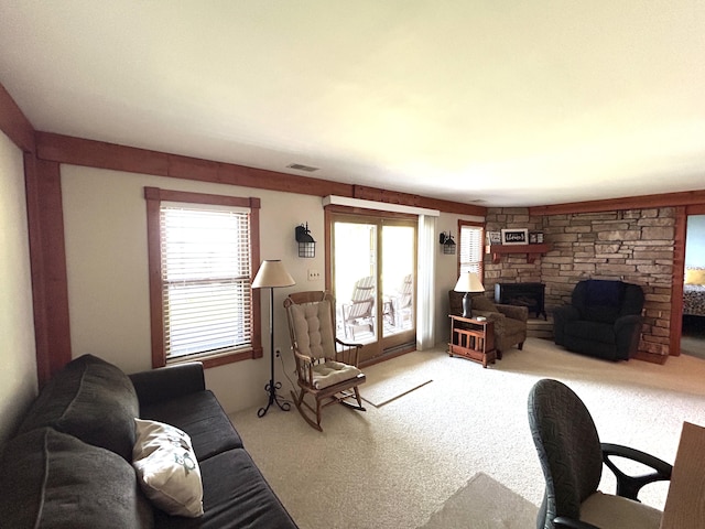 5392 Silver Beach Rd, Onaway, MI 49765 - living area featuring carpet and a stone fireplace