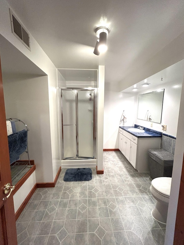 5392 Silver Beach Rd, Onaway, MI 49765 - full bath featuring a stall shower, vanity, baseboards, toilet, and tile patterned floors